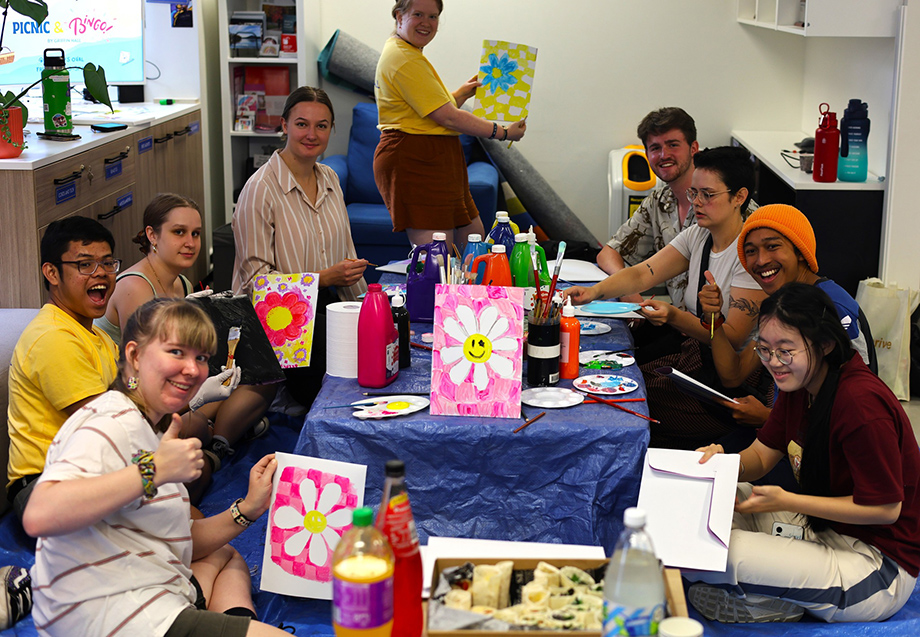 A lot of students painting flower on the paper