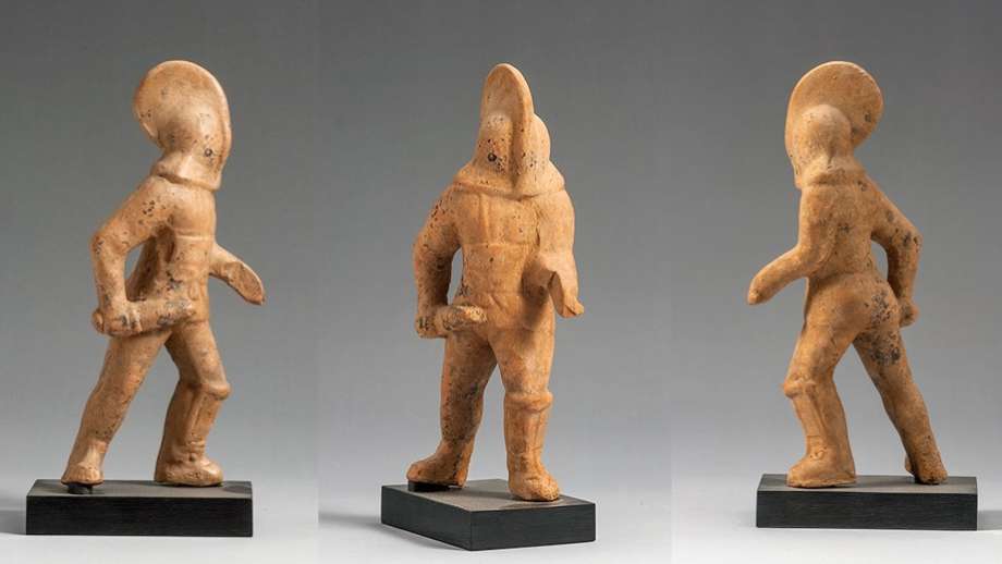 Three different views of a Gladiator figurine, made from clay. The figure lunges forward on his left leg. He wears a helmet that totally encloses the head, body armour and a single rectangular greave on the left leg. He carries a short sword in his right hand. The left arm is broken where the shield was attached. One can see the lattice on the front of the helmet through which the gladiator could see, and the tie at the front of the breastplate.
