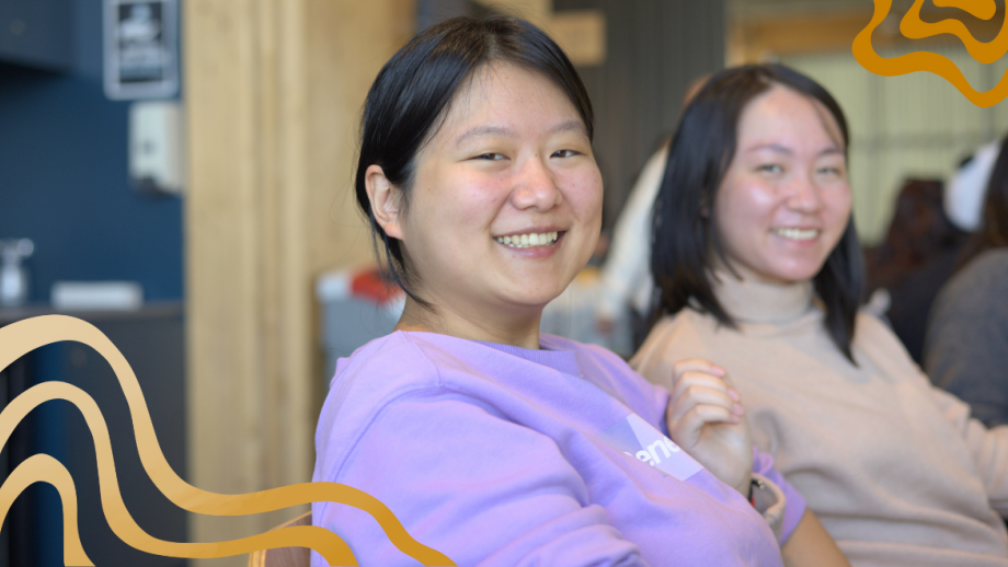 2 students looking at the camera smiling
