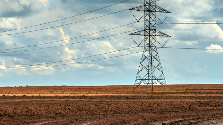 Powerlines in red dirt in a rural landscape
