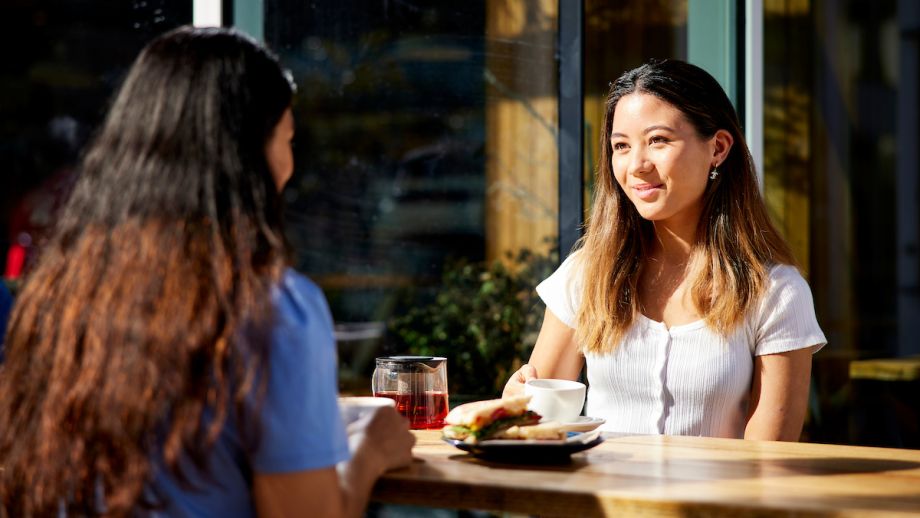 Two women talking over a light lunch.