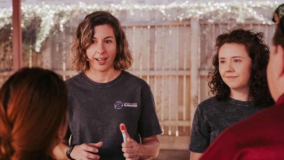 Two doctors holding a self-collection cervical screening test. 