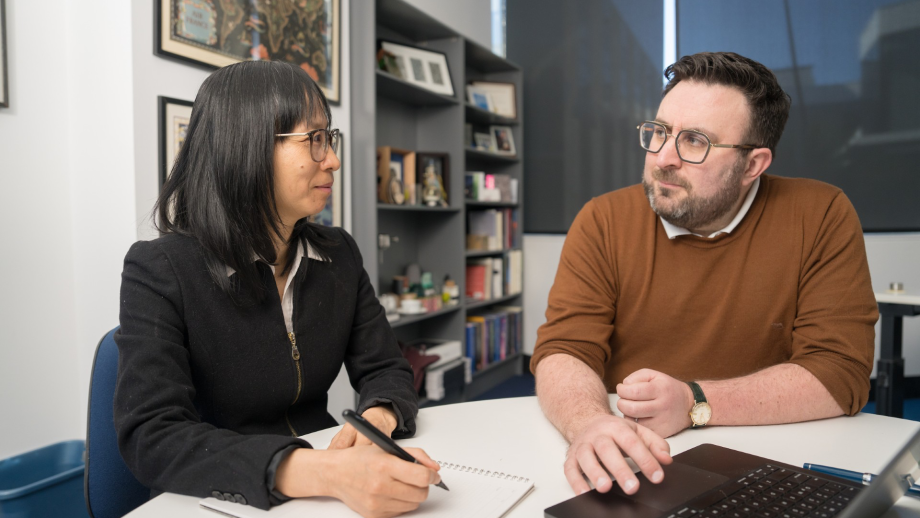 Associate Professor Nhung Nghiem and Professor Mark Polizzotto sit at a desk looking at one another