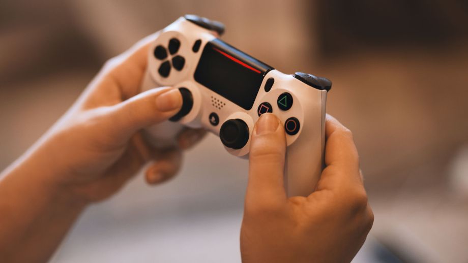 A person holding a gaming controller