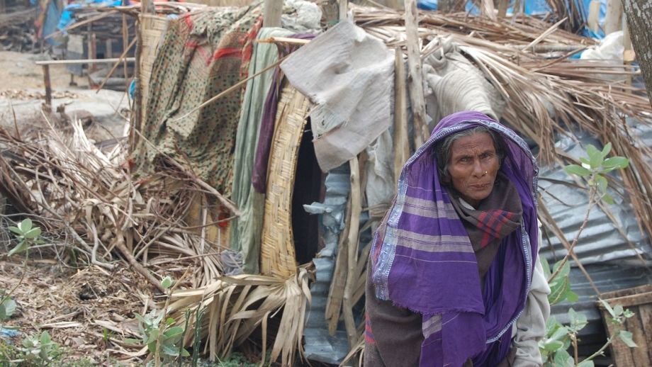 Image of woman walking past makeshift shelters, Cyclone Sidr aftermath, Bangladesh 2007, by Direct Relief, on flickr, used under CC BY-NC-ND 2.0 licence.