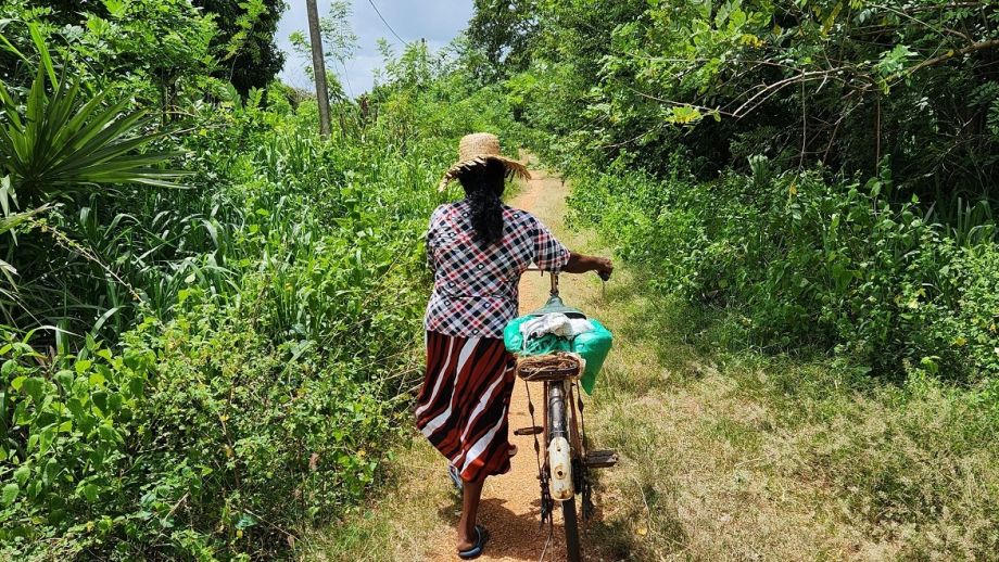Image of woman returning home after selling vegetables in a village in Sri Lanka, supplied by Viyanga Gunasekera, all rights reserved.
