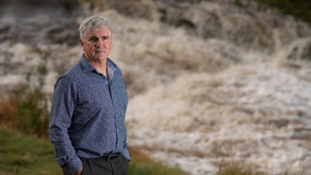 Professor Mark Howden standing next to a river