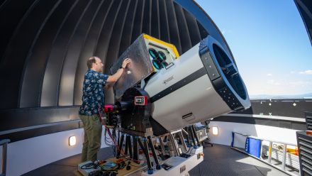 Professor Francis Bennet (pictured) with a state-of-the-art telescope at the ANU Quantum Optical Ground Station (QOGS), capable of providing space-to-ground laser communications.