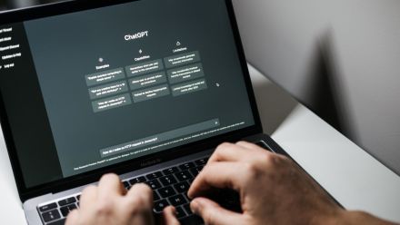 Person typing into ChatGPT on their laptop
