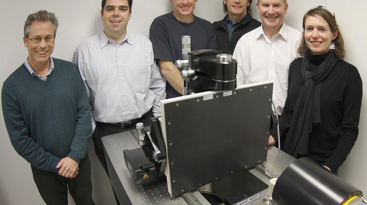 Mr Tim Sawkins, Dr Victor Pantano, Associate Professor Adrian Sheppard, Dr Trond Varslot, Professor Tim Senden, Dr Anna Carnerup standing in front of the first computed tomography system sold by ANU to Lithicon. 