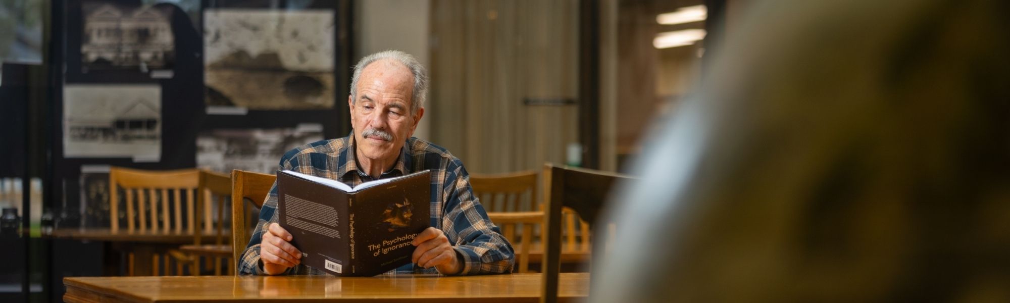 Smithson reading a book in a room