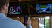 Man watching sport with phone betting