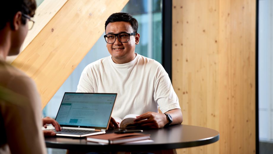 two men leaning over laptop
