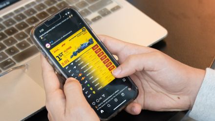 A person scrolls social media on their phone.