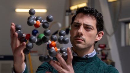 ��������Professor Nicholas Chilton holding a 3D printed structure of a molecule comprised of different coloured atoms