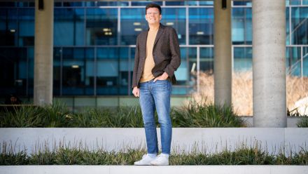 Full length shot of Sergey. he's facing the camera with one hand in his jeans pocket.