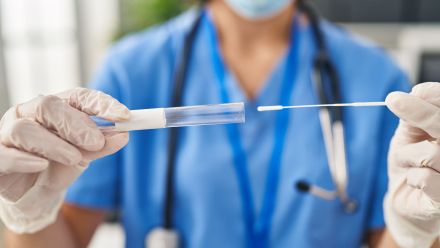 Doctor holding a COVID-19 test.