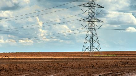 Powerlines in red dirt in a rural landscape